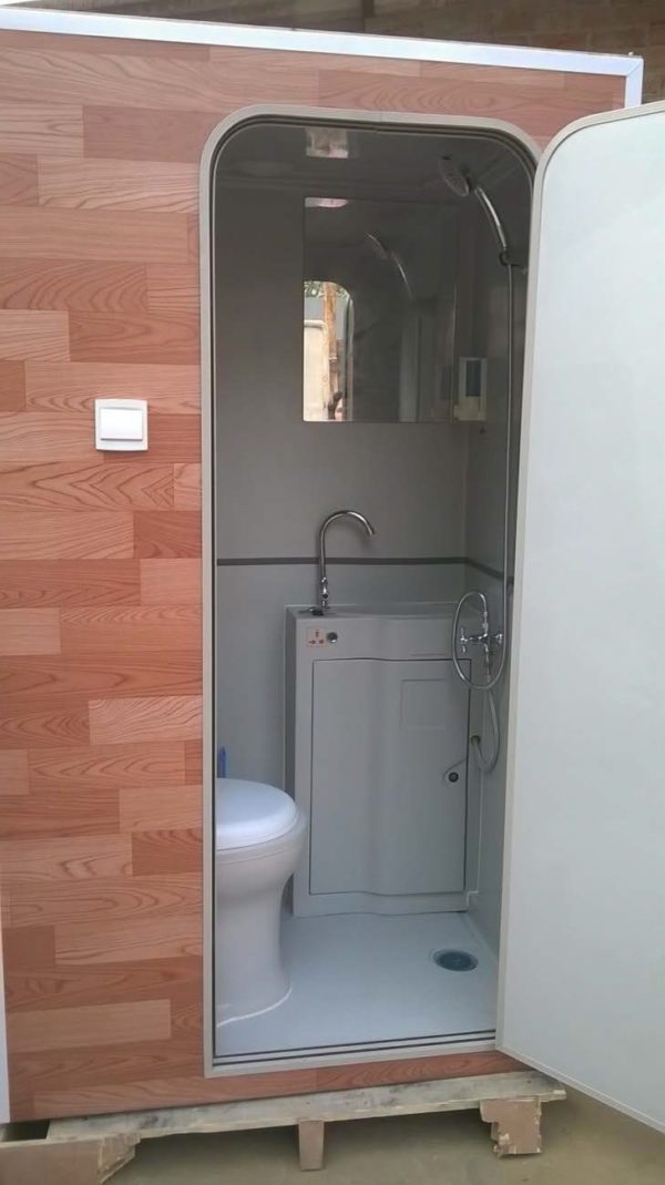 Bus shower cabin with toilet is fitted as all in one toilet facility